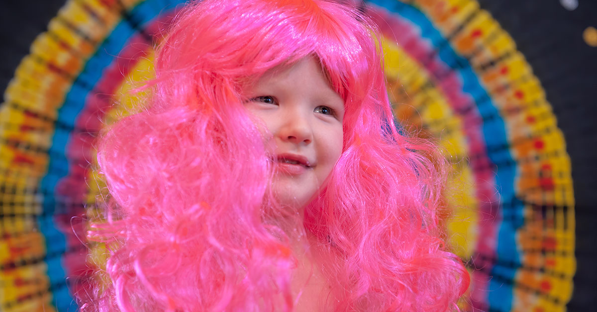 child wearing pink wig