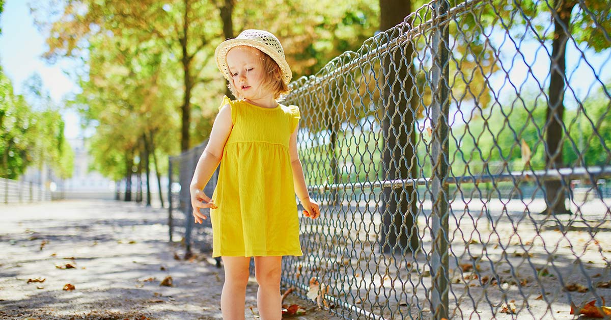 little girl in yellow sundress and hat