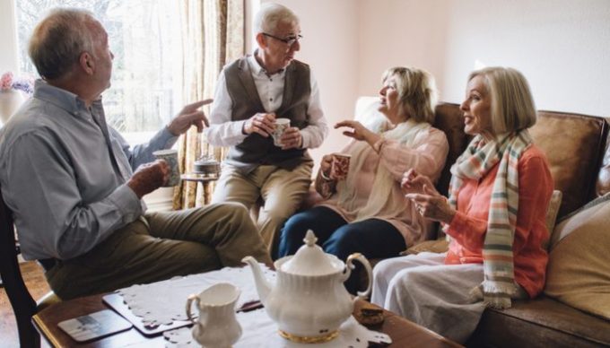 group of elderly people having tea
