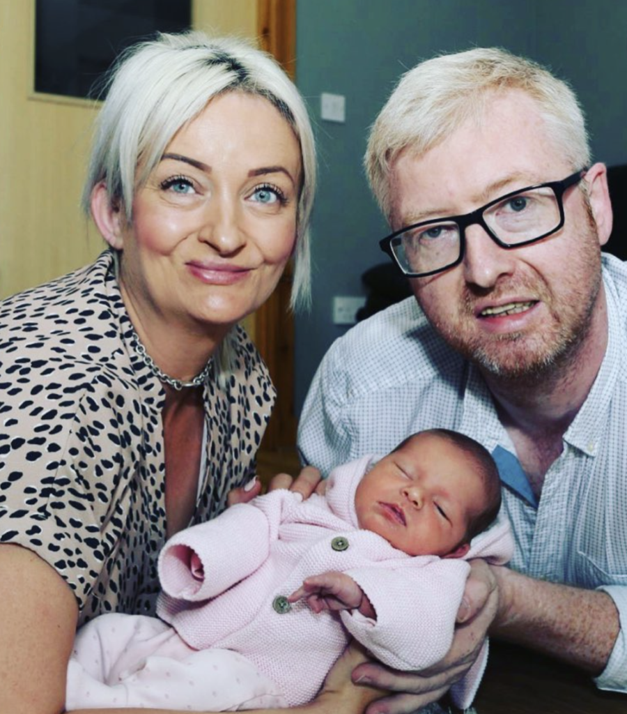 Alexis Brett and husband holding new daughter