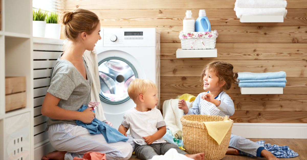 a mother and child doing laundry together