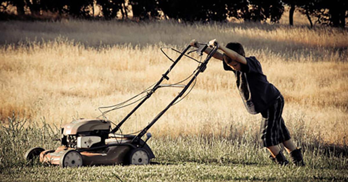 boy mowing a lawn