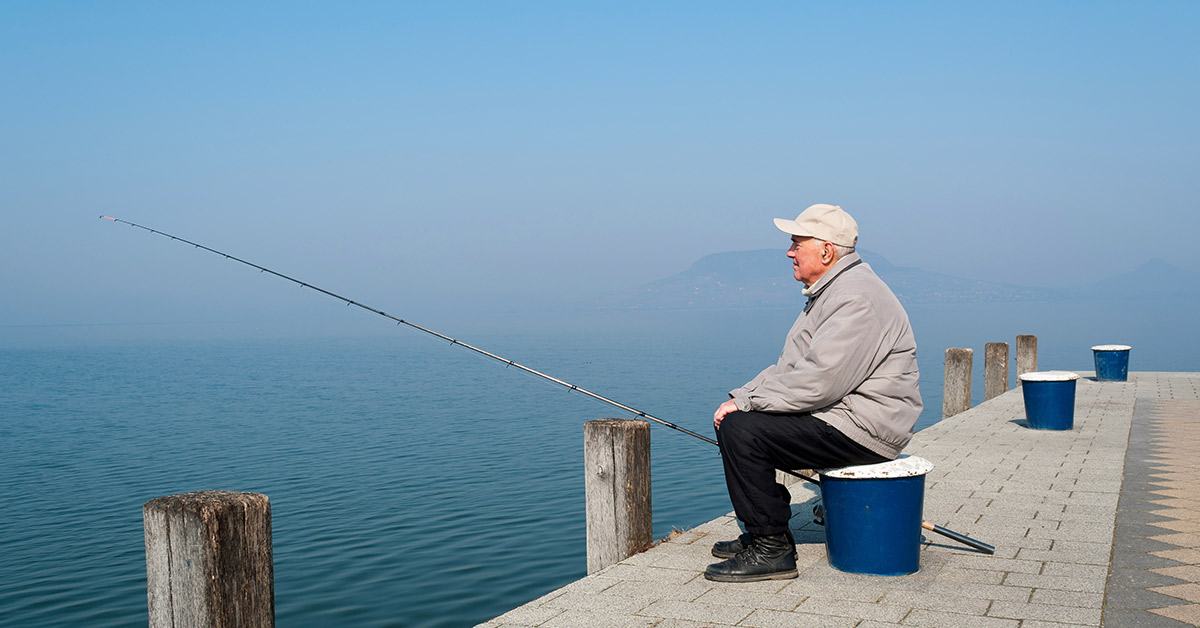 elderly man fishing on doc