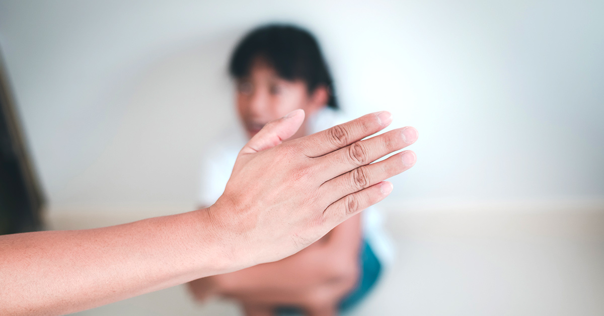 a hand being raised towards a child