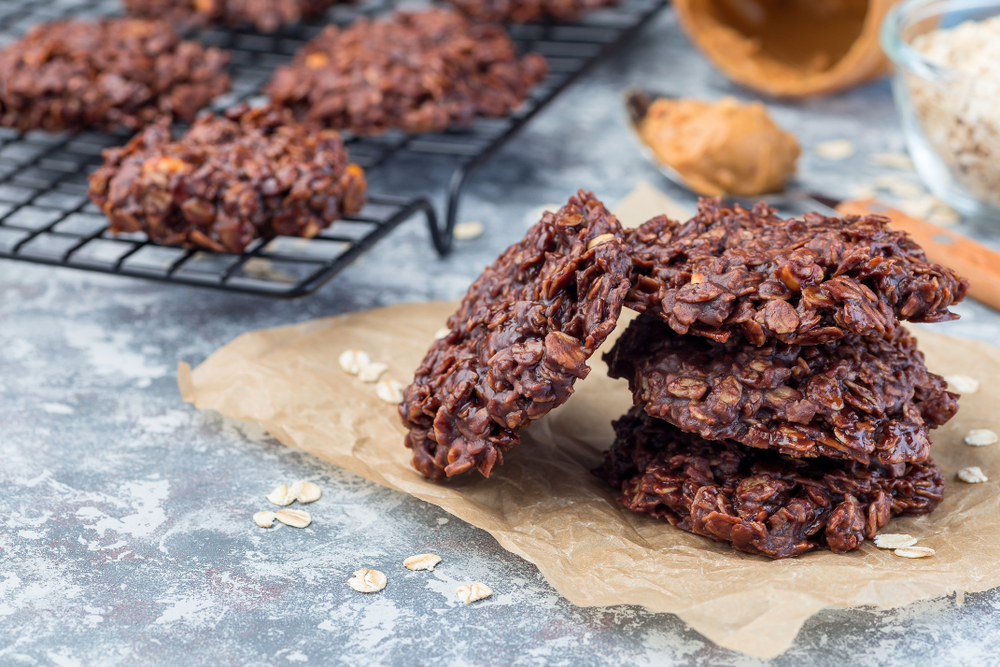 Flourless no bake peanut butter and oatmeal chocolate cookies on a parchment, horizontal, copy space