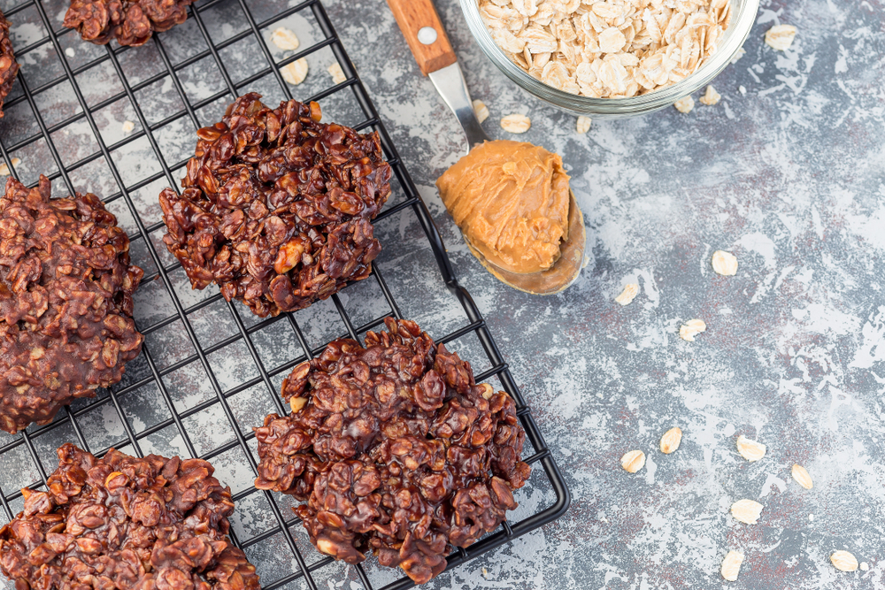 Flourless no bake peanut butter and oatmeal chocolate cookies on a cooling rack, horizontal, top view, copy space