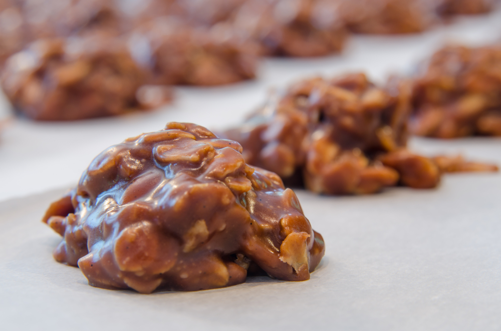 A close up of chocolate and peanut buter oatmeal cookies on parchment paper