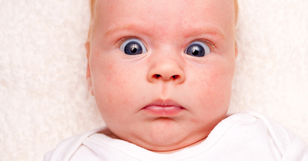 infant looking surprised and shocked is wide eyes
