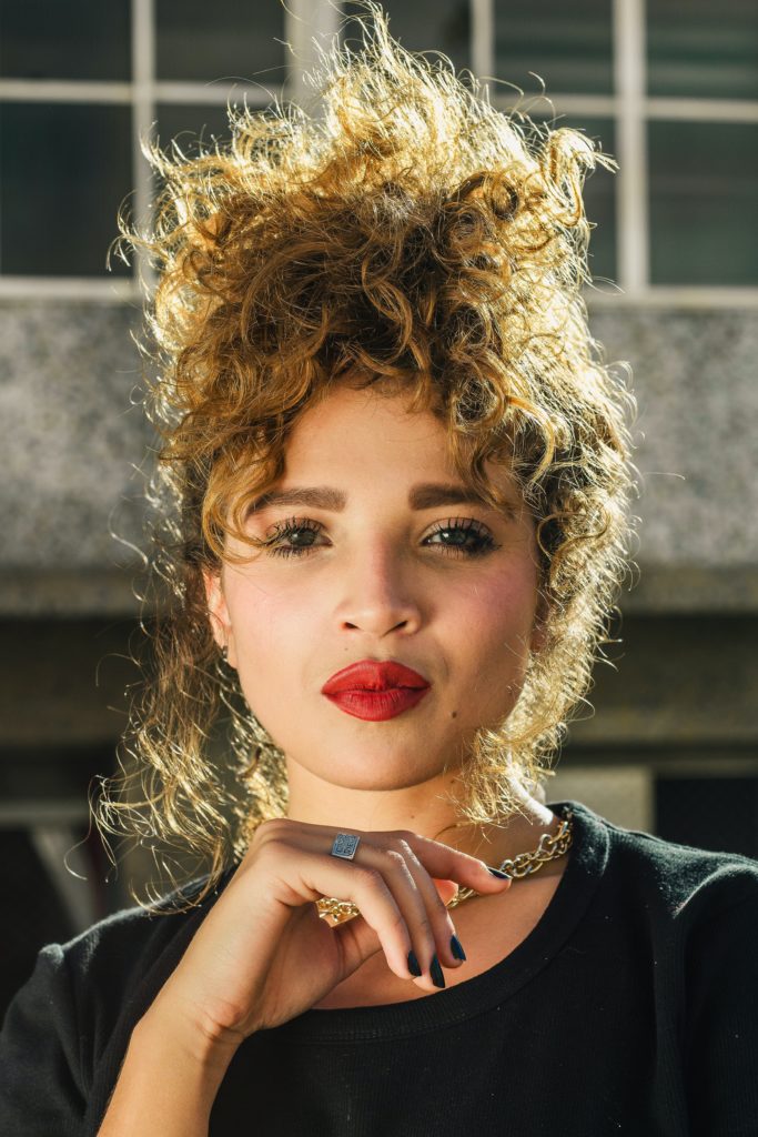 curly hair, woman, necklace, smiling