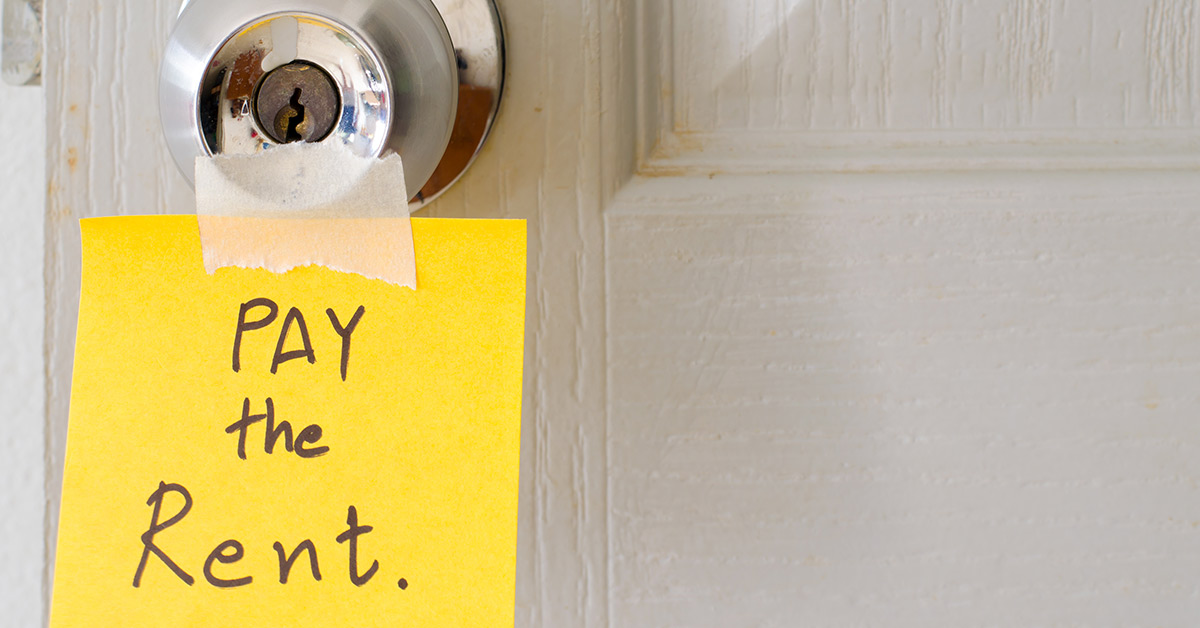 pay the rent sticker on a door knob