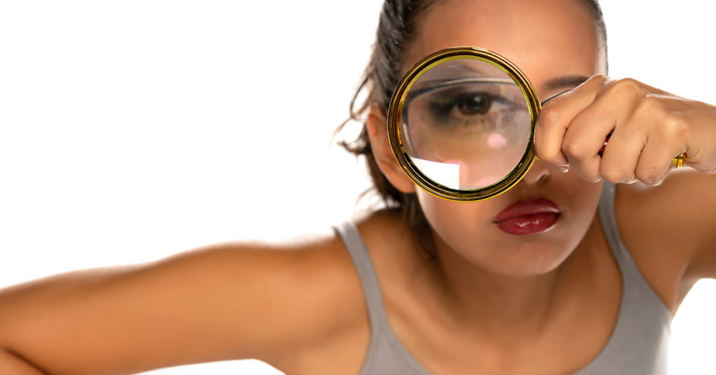 woman using magnifying glass 