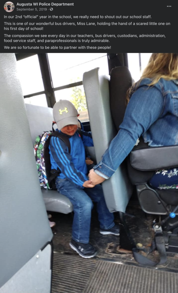 bus driver holds boys hand on first day of school