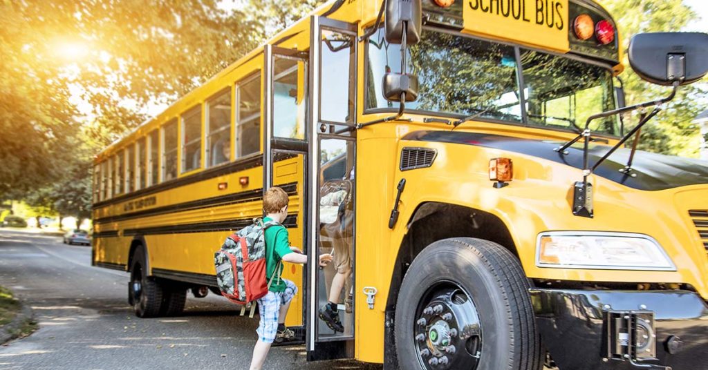 Touching Photo Of Bus Driver Holding Boy’s Hand On First Day Of School Goes Viral - Featured image