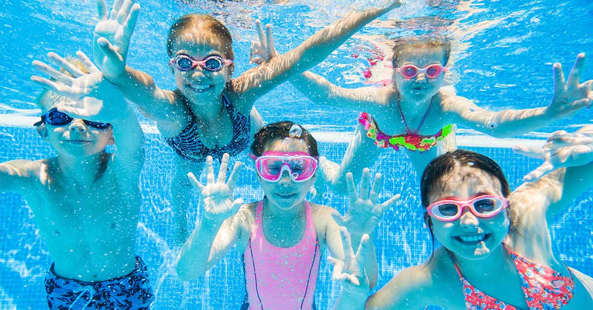 kids swimming underwater in pool