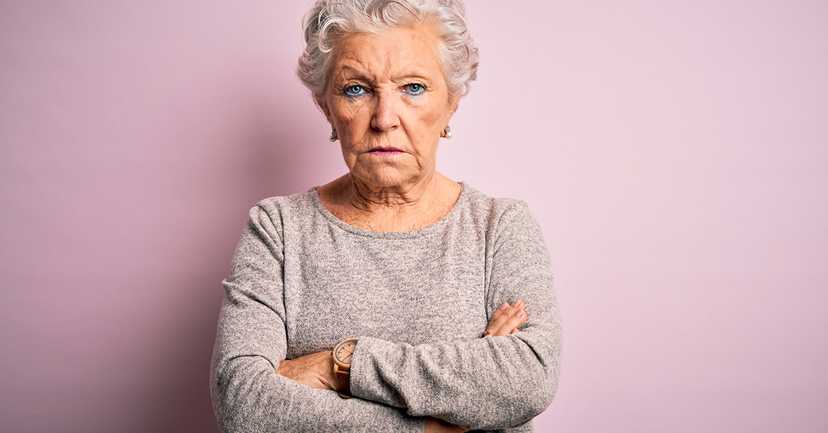 elderly woman with arms crossed