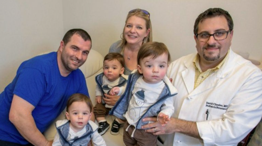 The Howards: From left, Michael Howard holding son Jackson; Amy Howard holding son Hunter and Dr. David A. Chesler holding another of the triplets, Kaden. 