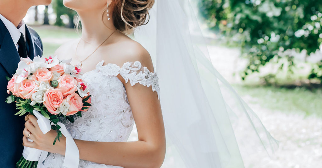 A bride who uses a wheelchair surprised her groom by walking down the aisle at their wedding - Featured image