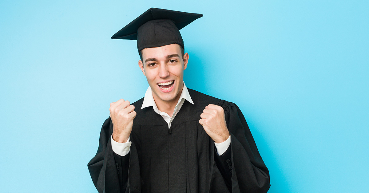 young male in graduation outfit with sky blue background