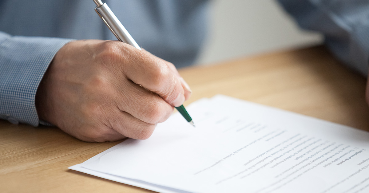person signing a document