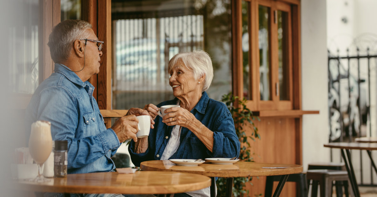elderly couple having coffee in a cafe