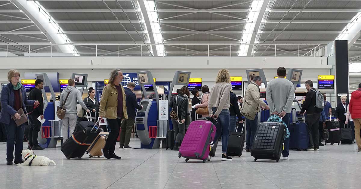 commuters lining at busy airport check in area