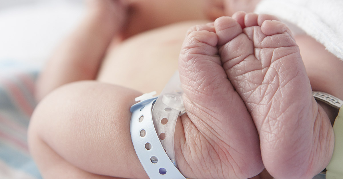 infant wearing hospital tag on ankle