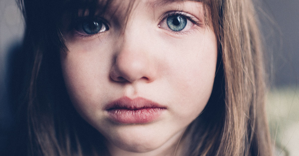 close up of young brunette girl with blue eyes