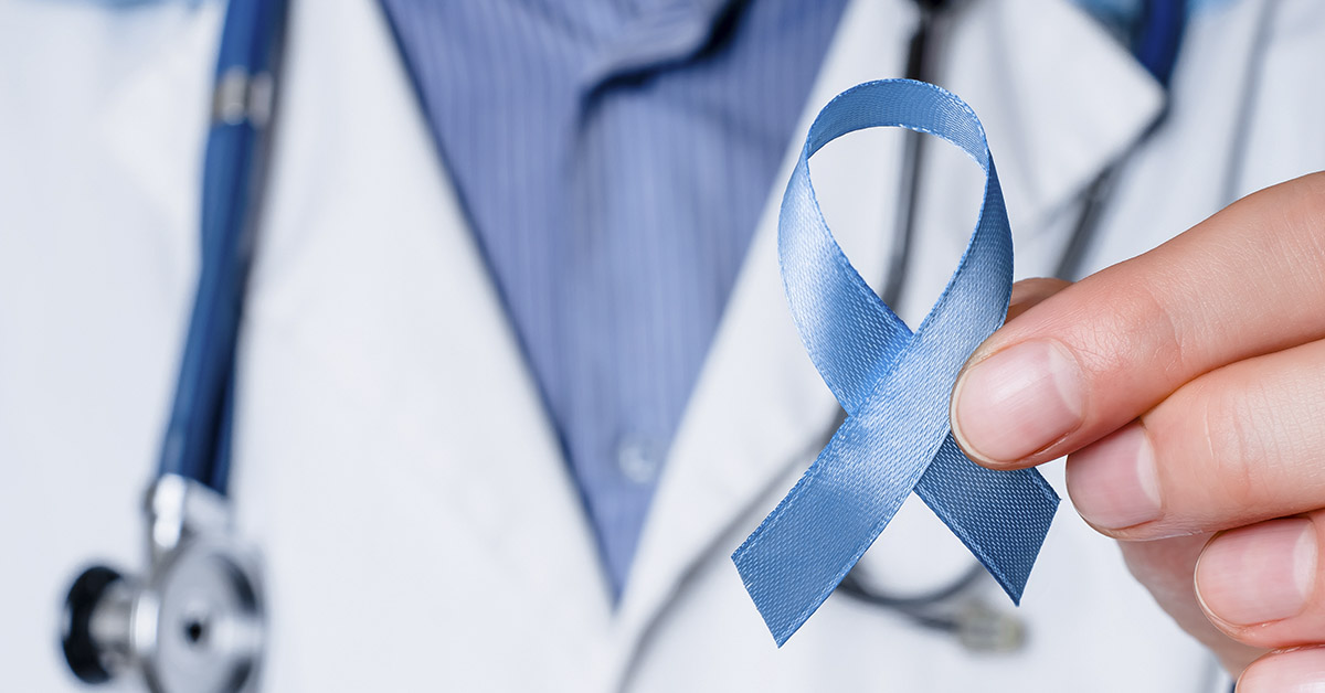 doctor holding blue cancer ribbon