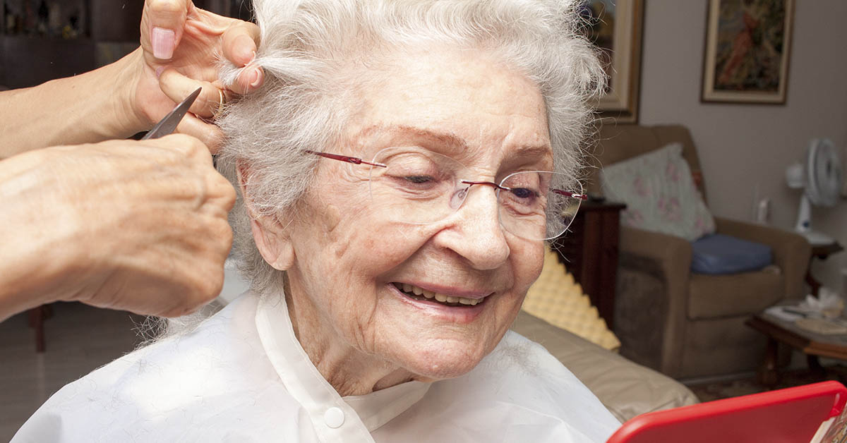 olderly woman having her haircut