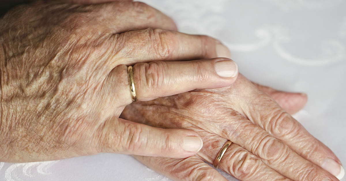elderly hands both wearing wedding rings
