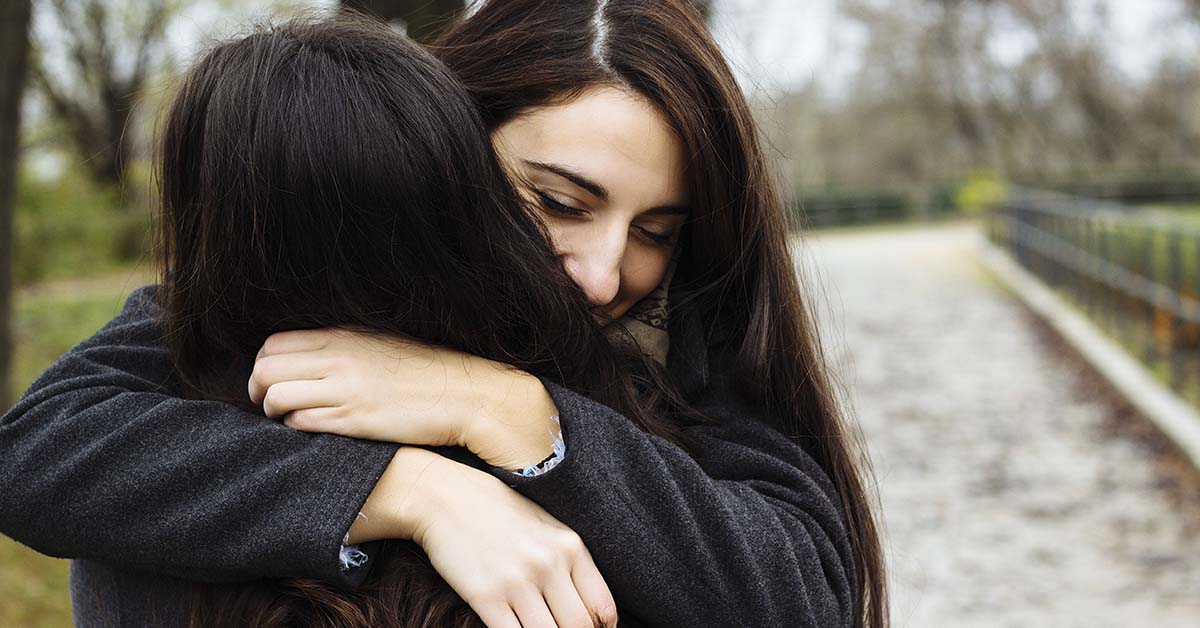 two female friends hugging