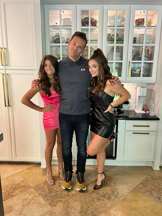 Matt Austin, with his daughters wearing their homecoming outfits
