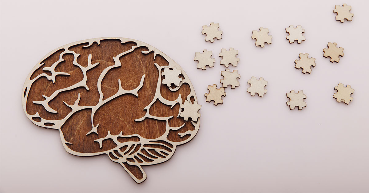 depiction of brain made of wood with puzzle pieces