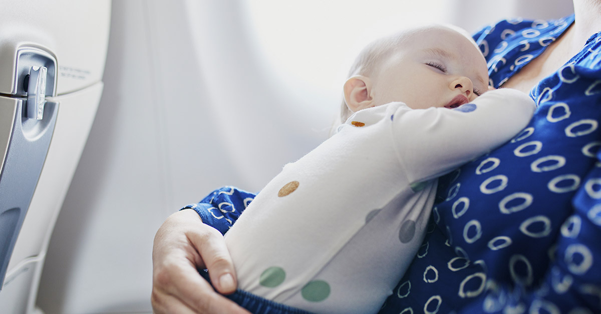 child in lap of parent during flight