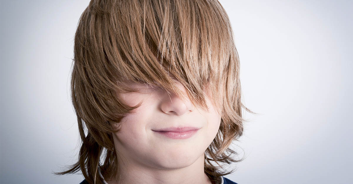 child with long hair in face