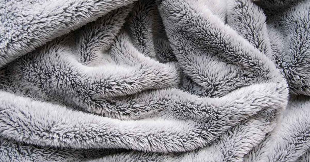 Woman Disguises Dog As Baby So They Can Visit Their Grandmother In The Hospital - Featured image