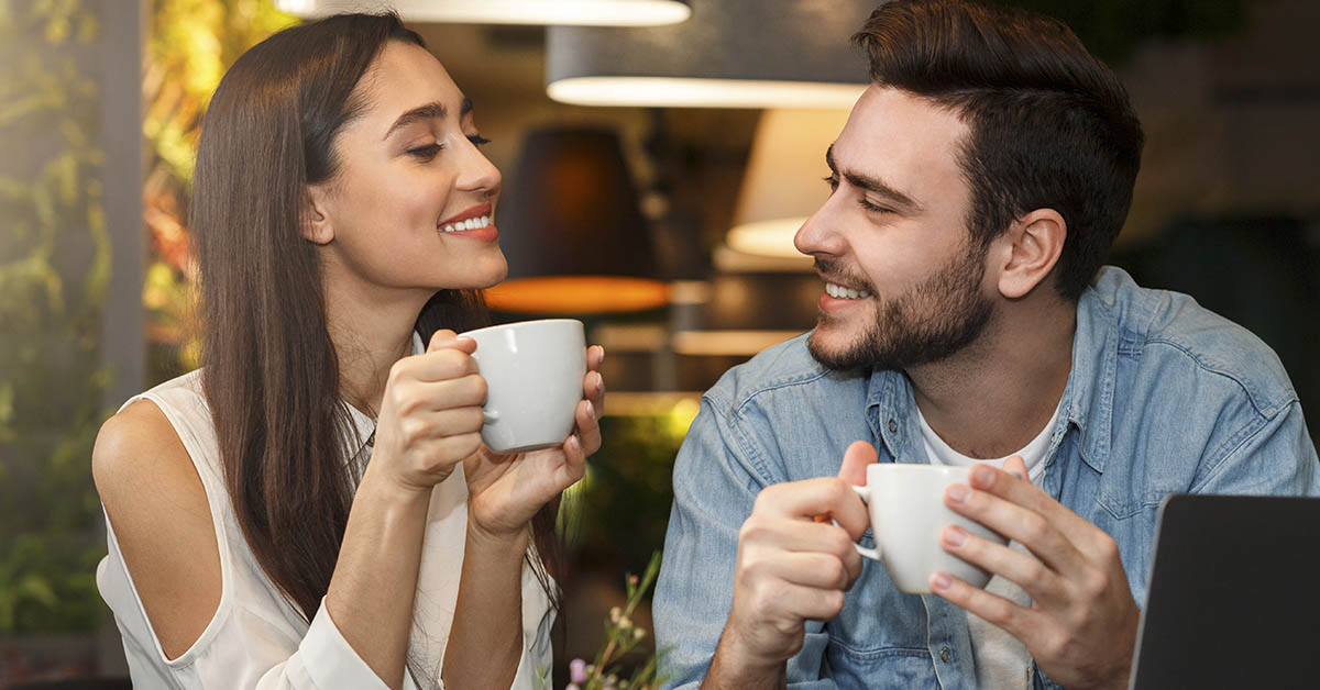 man and woman couple talking over coffee