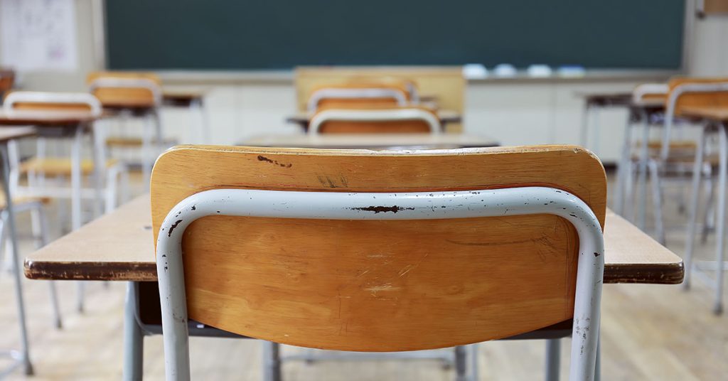The reason one teacher has kept an empty chair in his classroom for 50 years - Featured image