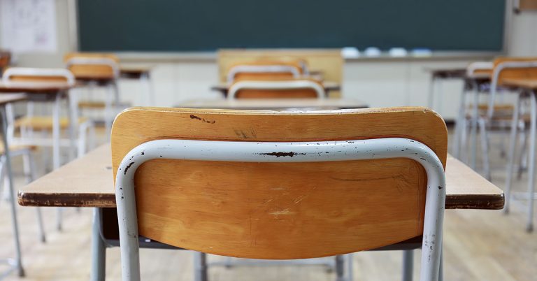 The reason one teacher has kept an empty chair in his classroom for 50 years - Featured image