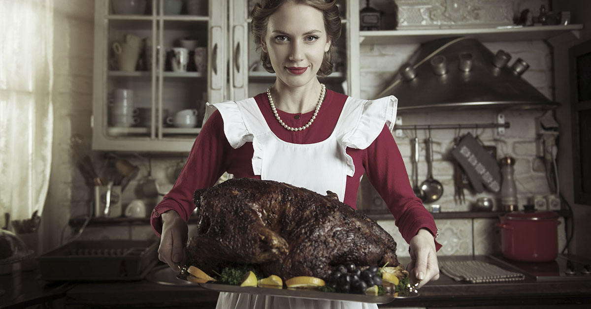 traditional 'housewife' holding a cooked turkey