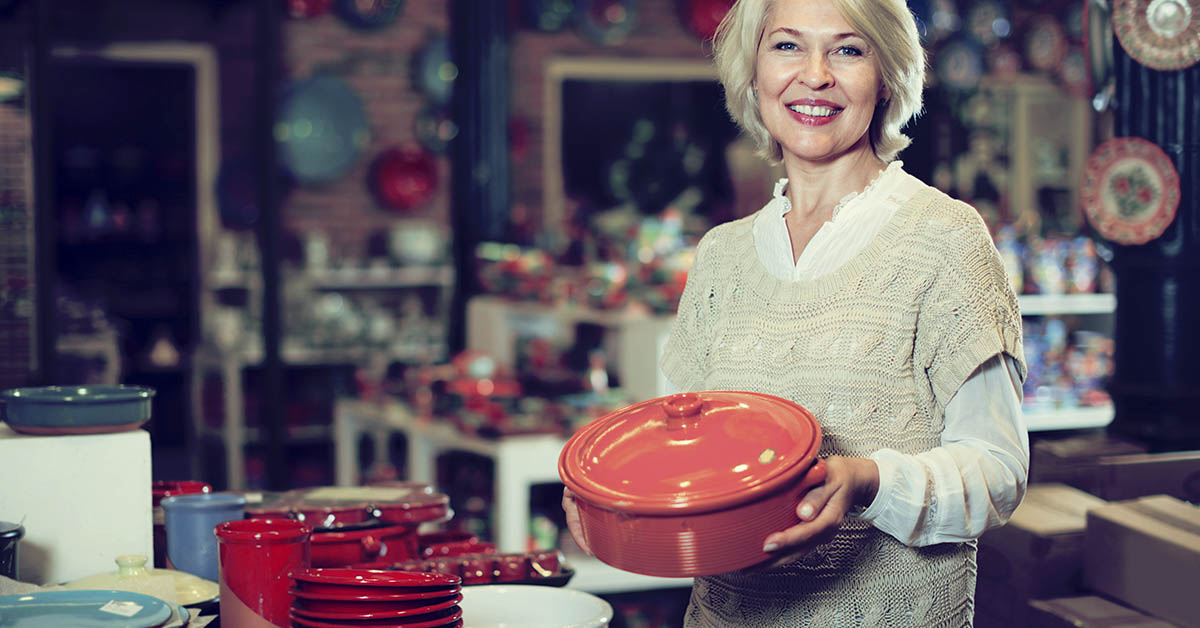 Mature woman buying ceramic cookware in the shop
