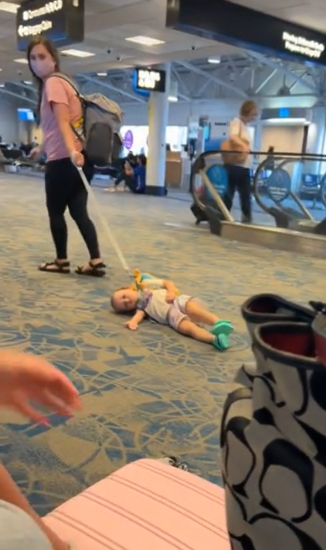 mother caught dragging her child on a leash through airport terminal