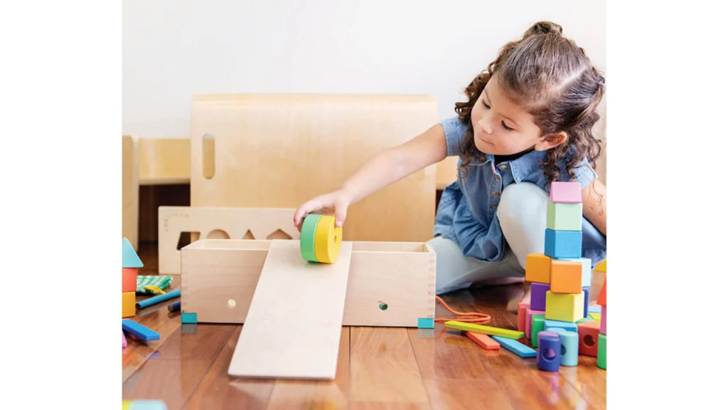 child playing with wooden blocks