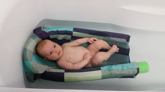 baby Scarlett in the bath - gently floating in a self-made contraption of a pillowcase with a pool noodle