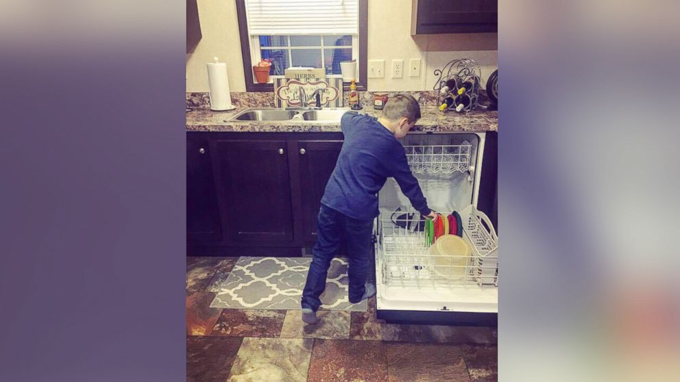Boy stacking dishwasher