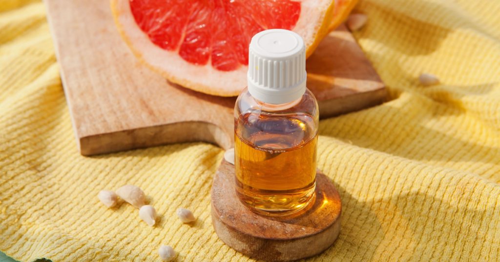 Bottle with grapefruit seed oil extract, slices of grapefruit
