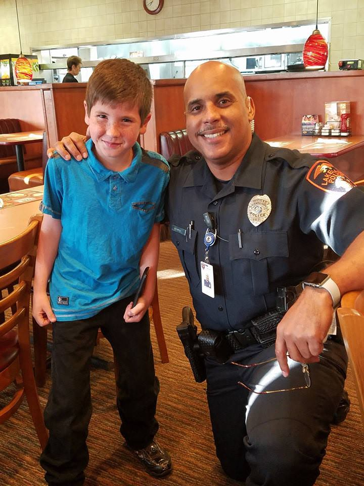 9-year-old Noah with police officer Eddie Benitez.