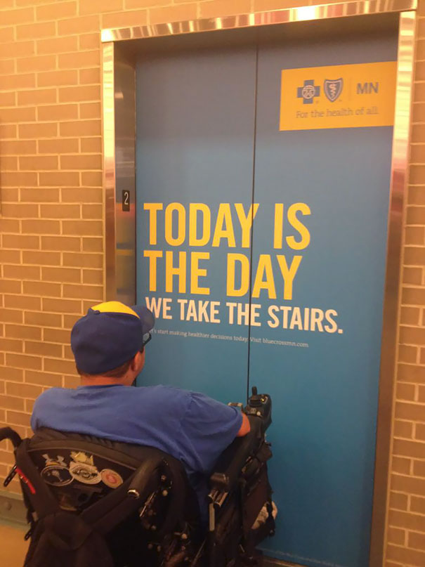 Man reading elevator sign