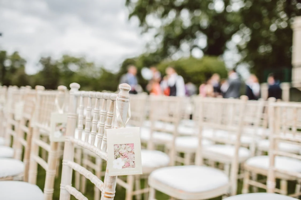 white chairs set up for guests at outdoor wedding 