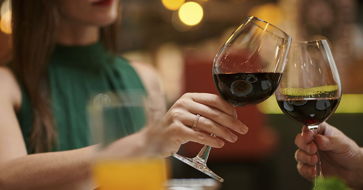 couple on first date drinking red wine in restaurant setting